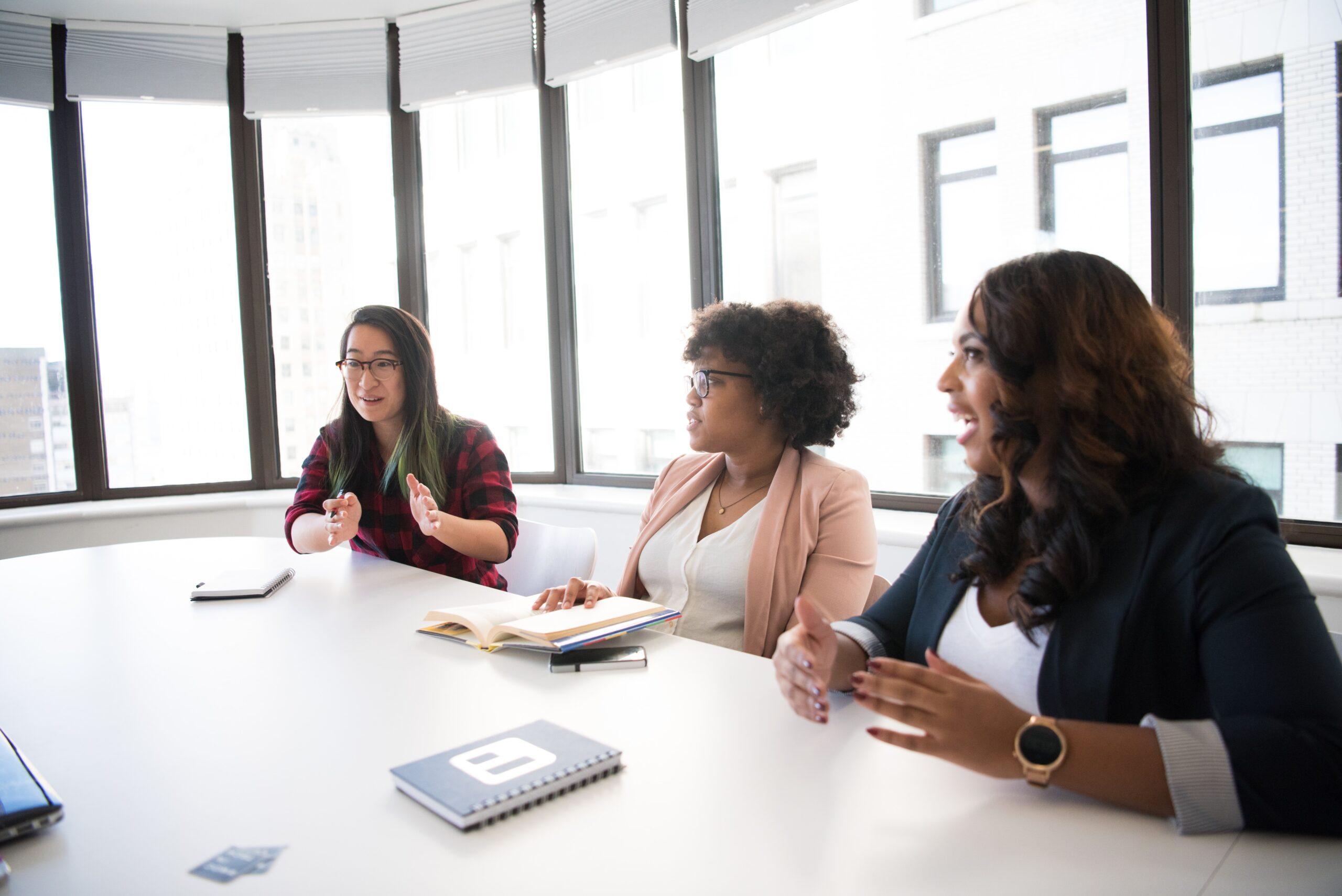 Women working and talking in downtown Canadian boardroom