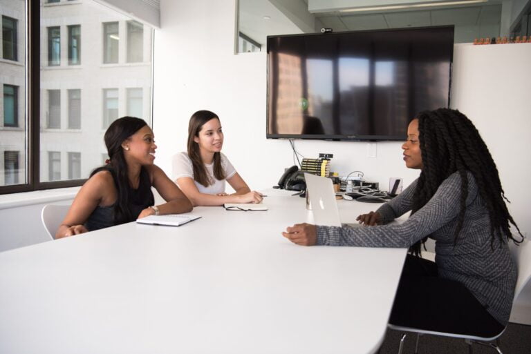 Women working and talking in downtown Canadian boardroom