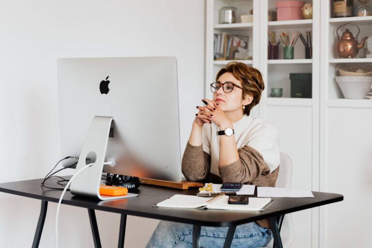 Woman working at computer in Canada